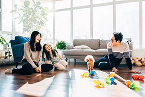 Young family playing toys at home